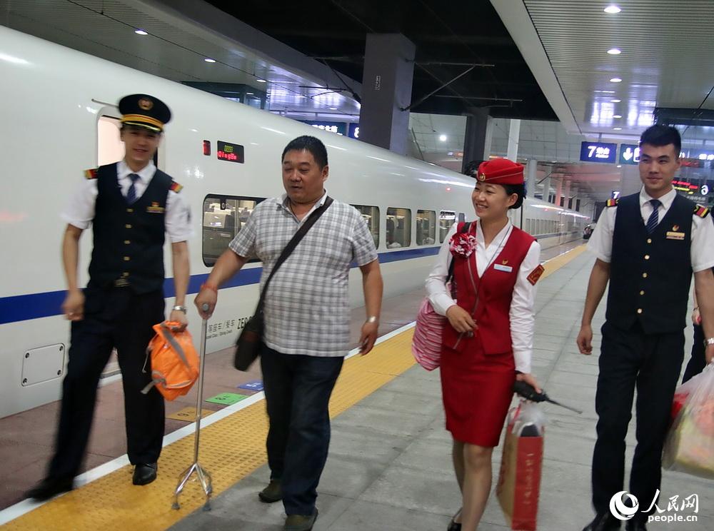 动少和车站人员帮助旅客不方便的旅客出站。