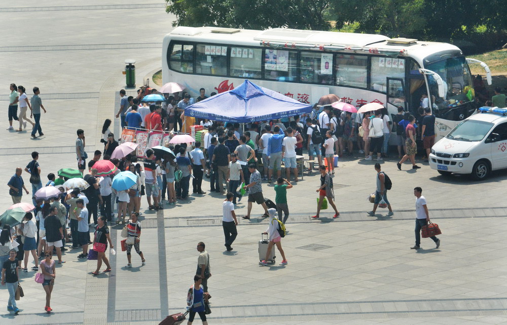 8月13日，市民在天津火车站广场的流动献血车前排队等候献血。