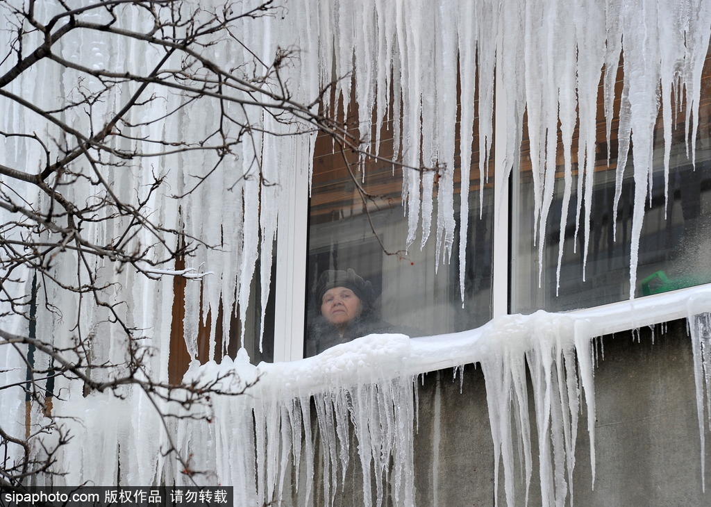 俄罗斯持续遭遇低温天气 居民楼现冰挂奇观