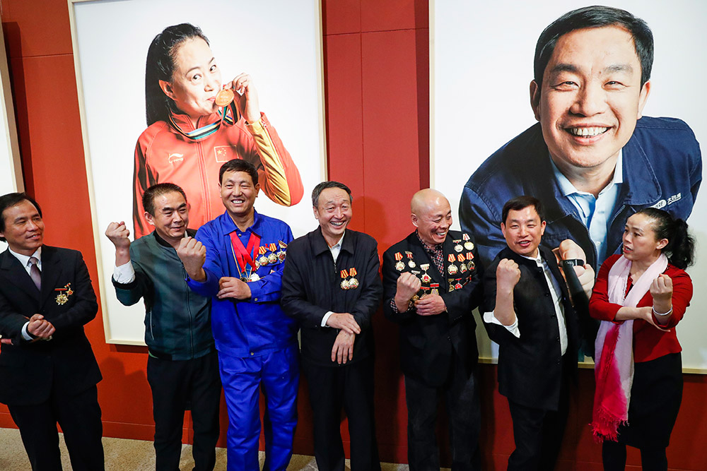 3月11日，展覽發起和主創人謝子龍（右二）與參加活動的全國勞模一起，擼起袖子拍照留念。