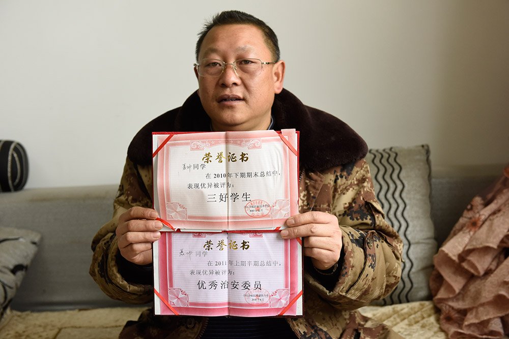 涼山彝族自治州雷波縣干部聶帥的父親展示兒子學生時代的獎狀（2月11日攝）。聶帥和同事梁恩宇在驅車指導貧困戶易地搬遷安全住房建設的路上遭遇交通意外犧牲。新華社記者 劉坤 攝