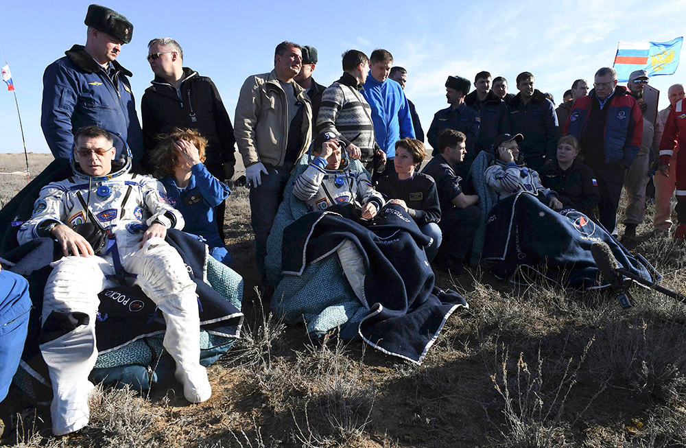 4月10日，在哈薩克斯坦杰茲卡茲甘附近，美國宇航員沙恩·金布羅（前左）、俄羅斯宇航員謝爾蓋·雷日科夫（前中）和安德烈·鮑裡先科（前右）安全著陸。新華社/路透