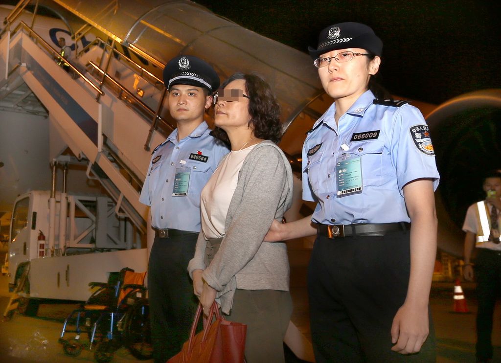 9月19日，警方人員在上海浦東國際機場將逃犯閔某押下飛機。 新華社記者凡軍攝