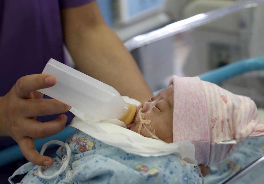 11月7日，在復旦大學附屬兒科醫院新生兒重症監護中心，醫護人員用捐贈的母乳喂養早產兒。 新華社記者 劉穎 攝