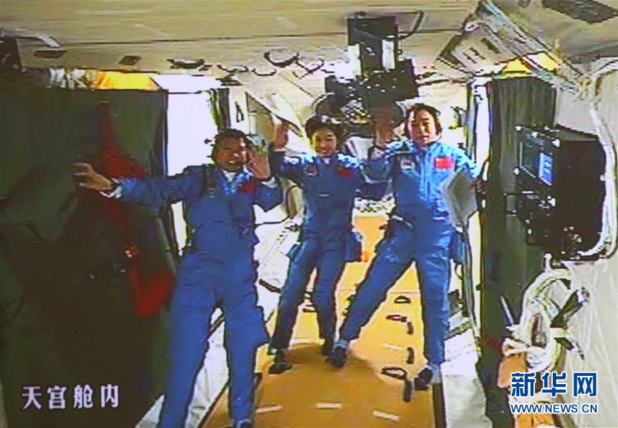 　2012年6月18日，北京航天飛控中心大屏幕顯示航天員景海鵬、劉洋、劉旺（從右至左）在天宮一號實驗艙內。