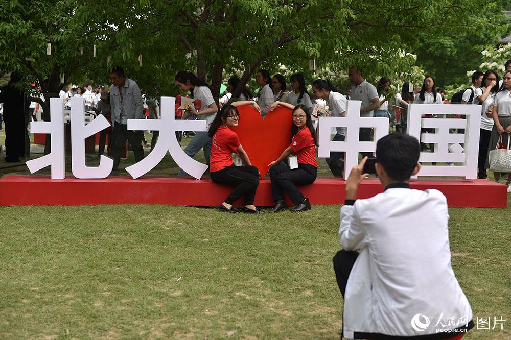 學生們在“百年五四”紀念板前，拍照留影。（人民網記者 翁奇羽 攝）