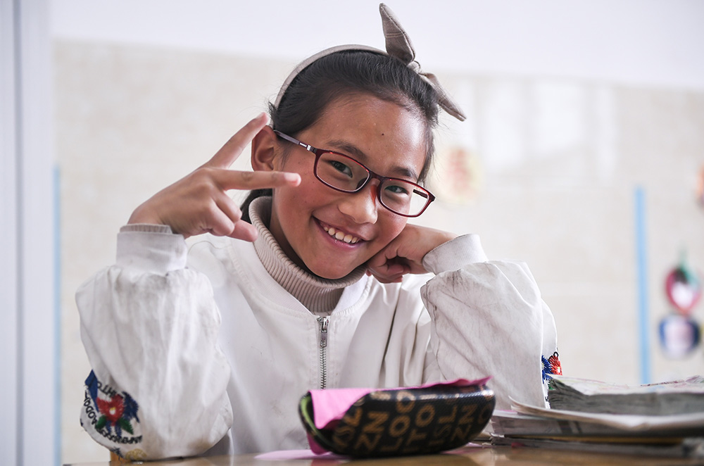 6月18日，戴上眼镜的扎西旺姆在若尔盖县民族寄宿制小学的教室里。