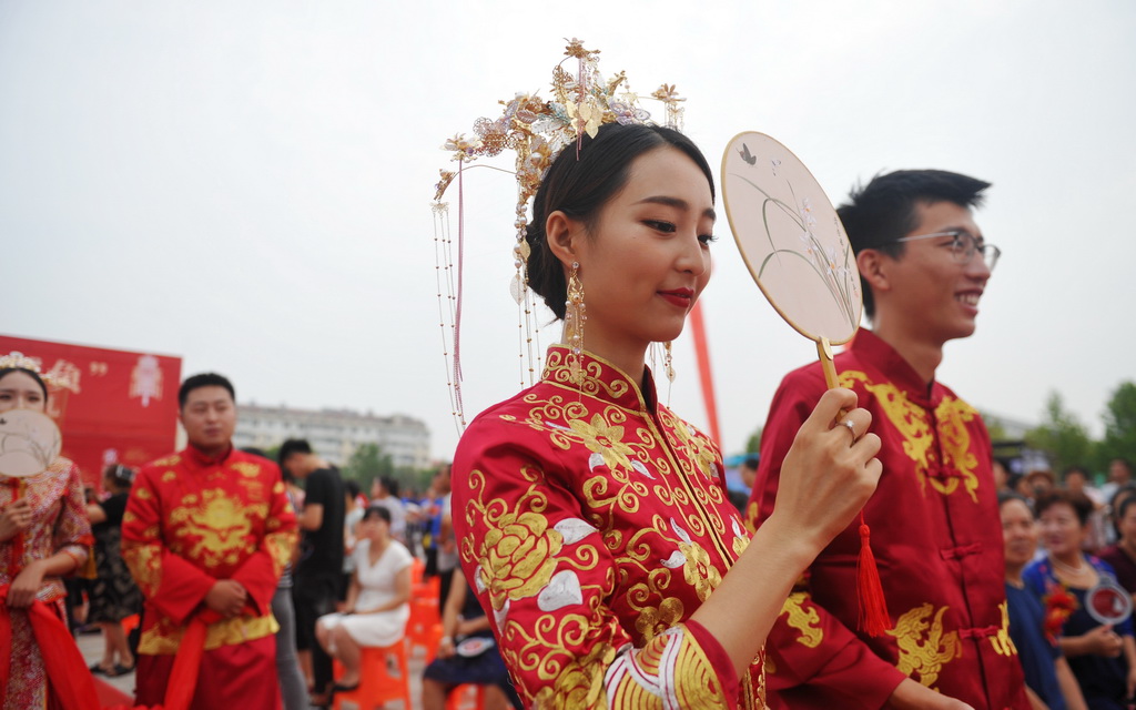 8月6日，在河北黃驊南海公園舉辦的“執手幸福·為愛減負”大型公益集體婚禮上，新人步入婚禮現場。