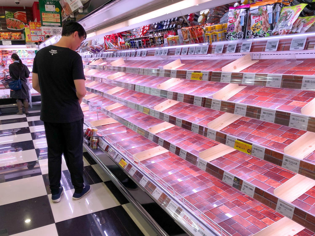 10月11日，在日本东京一家超市，部分食品类商品被抢购一空（手机拍摄）。新华社记者 马曹冉 摄