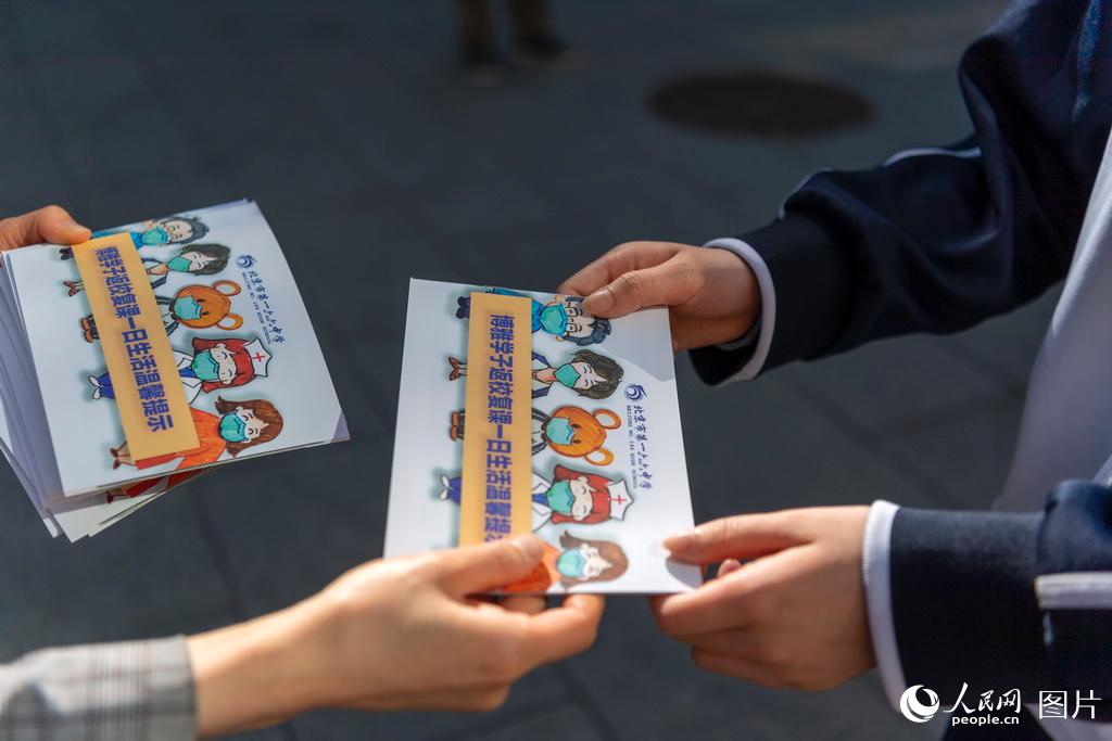 5月11日，在北京市第一六六中學，學生入校后都會收到一本復課一日生活溫馨提示手冊。（人民網記者 翁奇羽 攝）