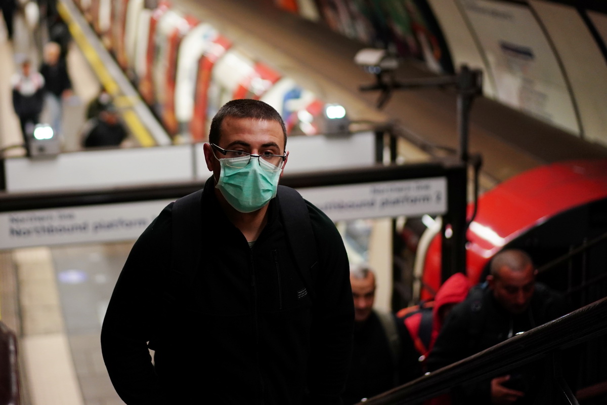 这是5月14日在英国伦敦一座地铁站拍摄的一名戴着口罩出行的男子。
