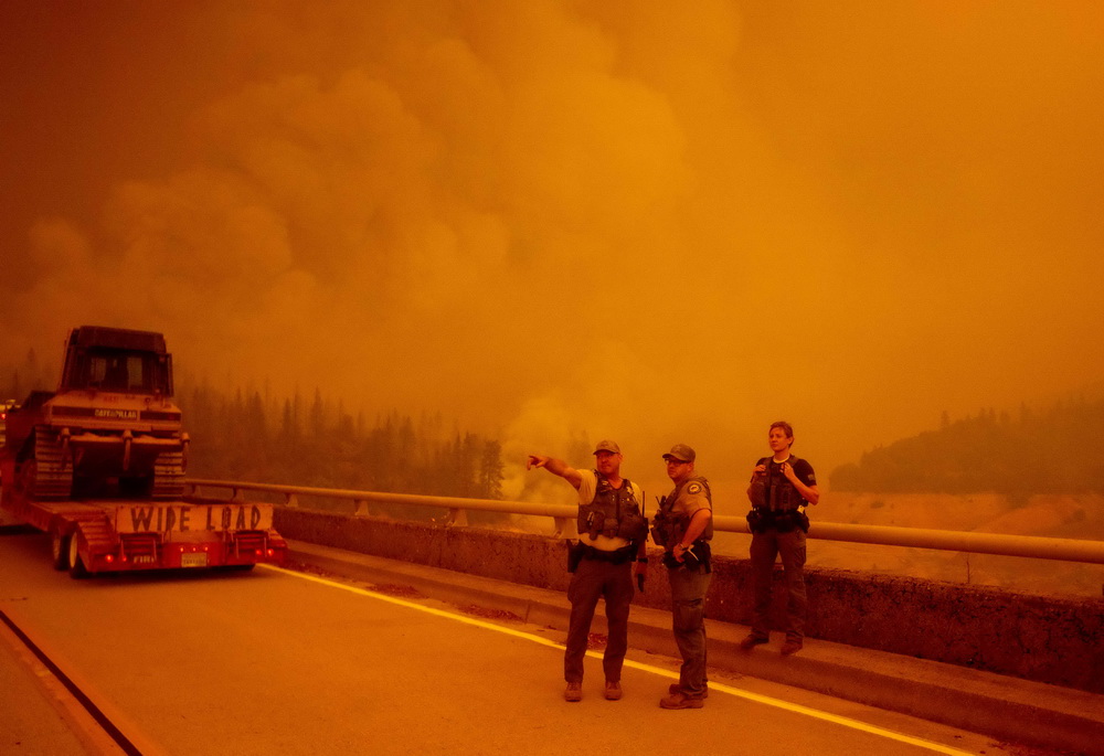 9月9日，在美国加利福尼亚州奥罗维尔，执法人员和消防人员准备进入山火区域。新华社/法新