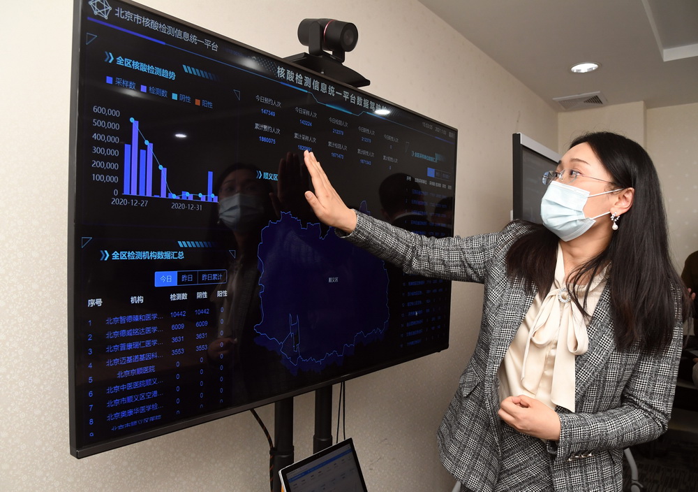 在北京市順義區的一處核酸檢測機構，工作人員介紹北京市核酸檢測信息統一平台（1月3日攝）。新華社記者 任超 攝