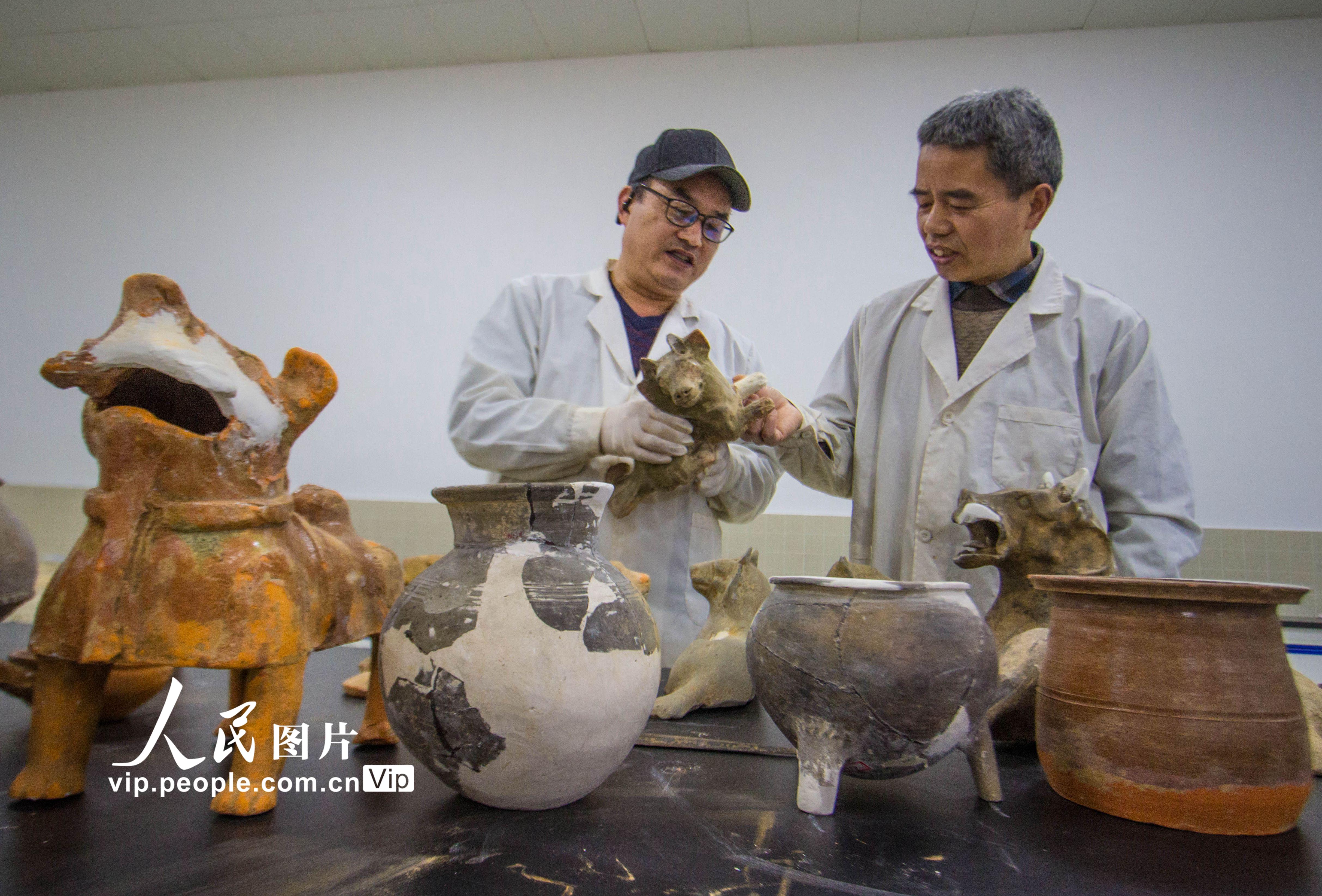 3月30日，河南省南陽市博物館文物修復室，技術人員在修復文物中進行技術討論。