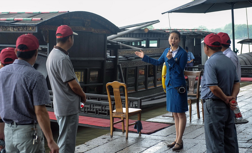 張一在紅船邊為參觀者講解（2012年6月28日攝）。新華社記者 韓傳號 攝