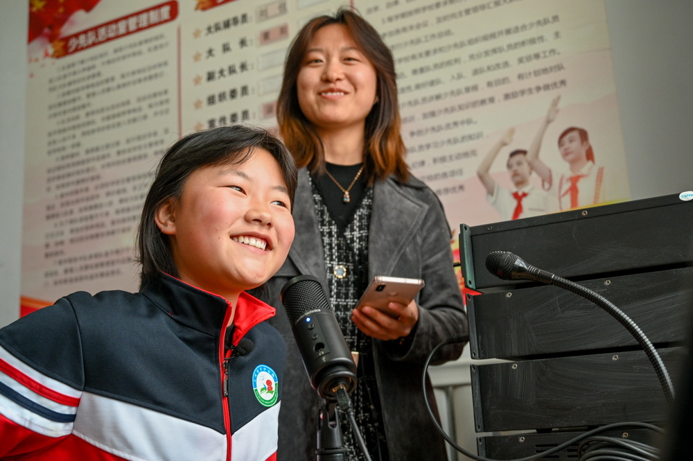 5月28日，老師郭美艷（右）給學生錄制朗讀音頻。