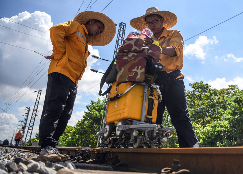 在柳州南编组站，柳州工务段的探伤工查看探伤仪检测数据（7月9日摄）。