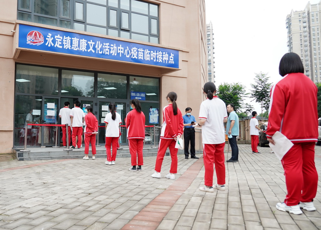 7月21日，來自首都師范大學附屬中學永定分校的學生在北京市門頭溝區永定鎮惠康文化活動中心疫苗臨時接種點排隊等候接種新冠病毒疫苗。新華社記者 張晨霖 攝