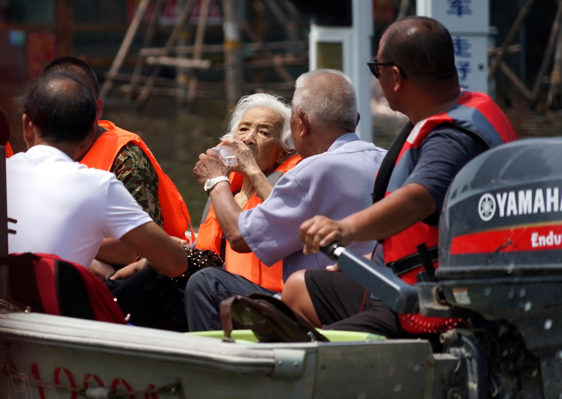 7月27日，救援人员在转移被困老人。新华社记者 李安 摄