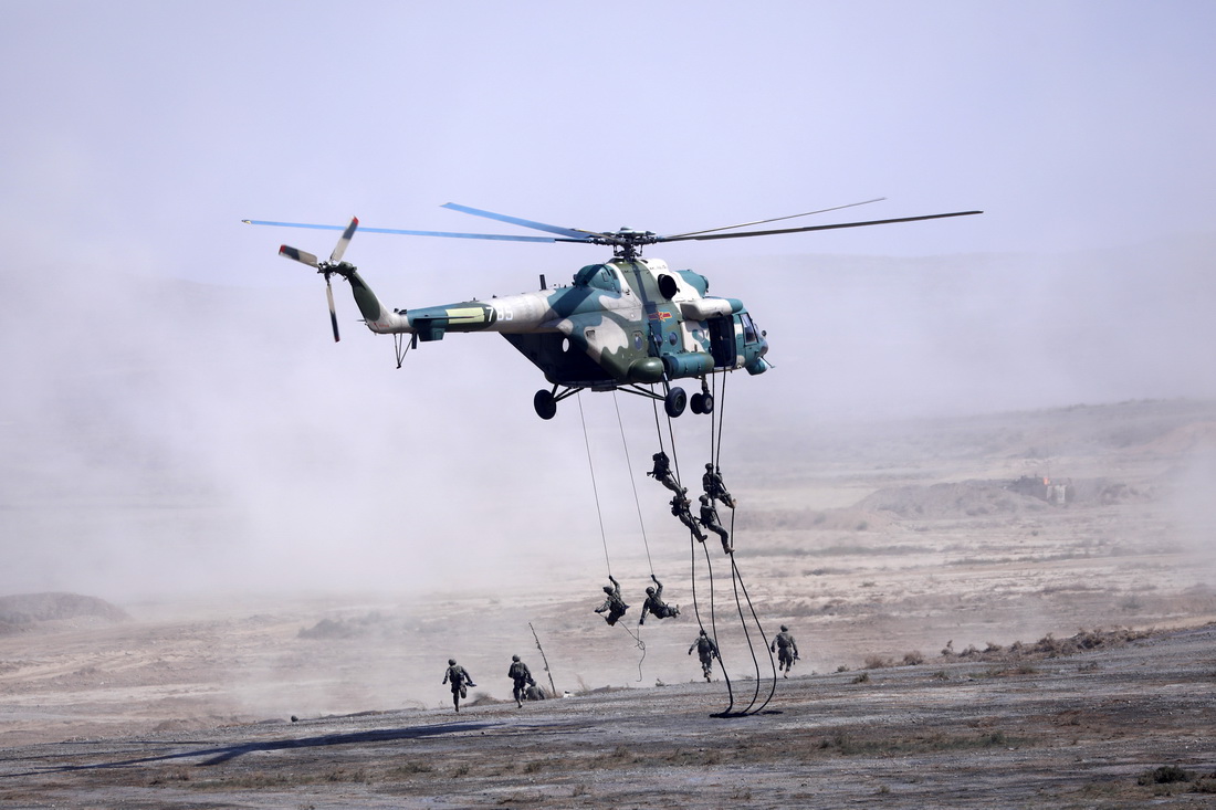 8月13日，在寧夏某合同戰術訓練基地，運輸直升機搭載陸軍特戰小隊至預定區域，特戰隊員實施索降。新華社記者 劉芳 攝