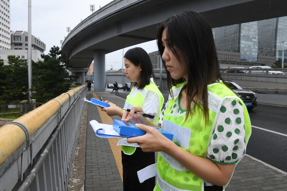 在北京西直门桥，刘晓珂（右）与王晟由进行数车（8月28日摄）。