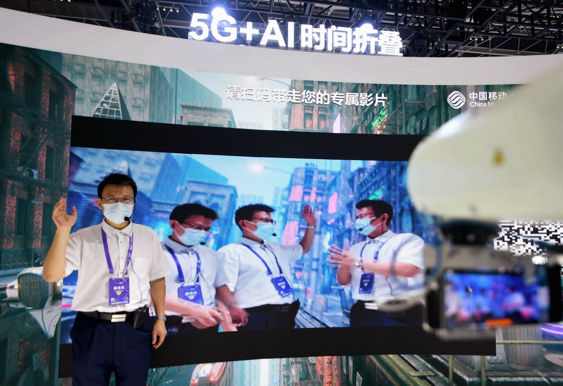 9月6日，工作人員在展示5G+AI時間折疊技術，可以實現人物實時摳像，將影像合成到一起后，實現三個“自己”相互打招呼。新華社記者 王曉 攝