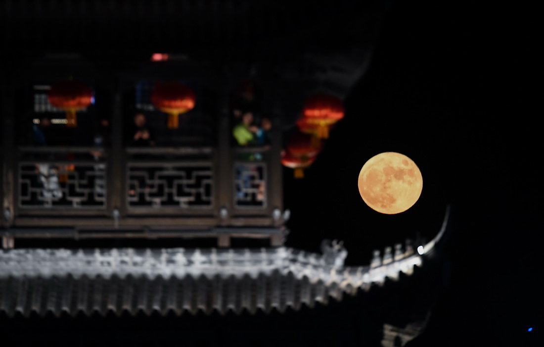 9月21日，游客在浙江建德嚴州古城澄清門樓賞月。新華社記者 徐昱 攝