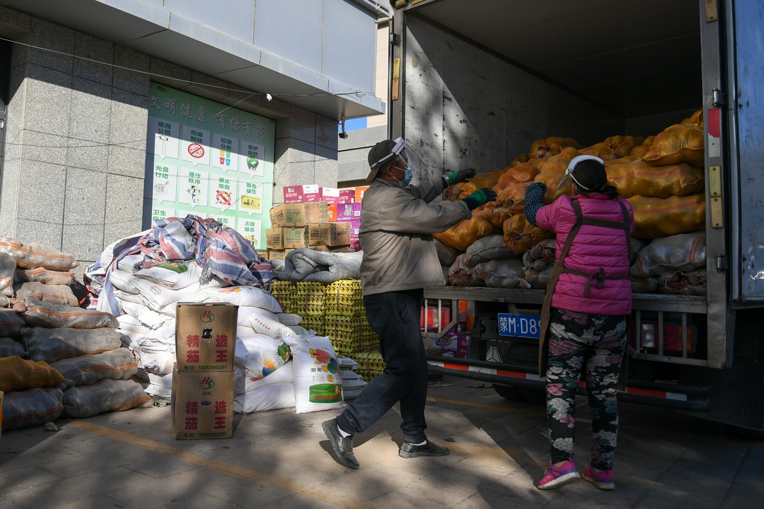 10月20日，在阿拉善盟額濟納旗達來呼布鎮民族生活超市外，超市員工在搬運物資。