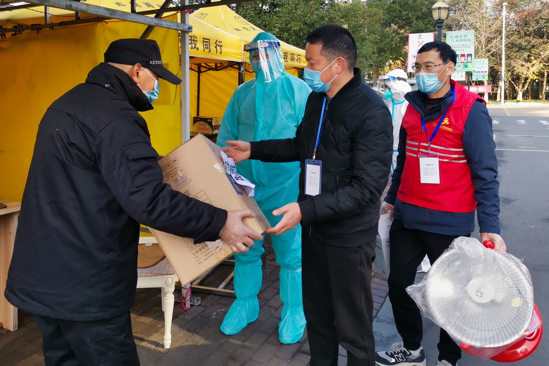 12月13日，浙江省宁波市镇海区庄市街道的爱心人士给卡口工作人员送来取暖器和生活物资。新华社发（胡学军 摄）