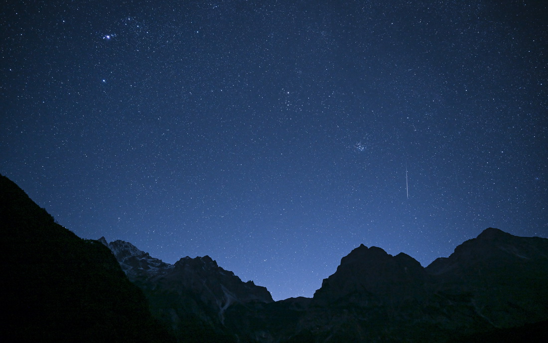 12月14日凌晨在云南省丽江市玉龙雪山脚下拍摄的双子座流星雨。新华社记者 江文耀 摄