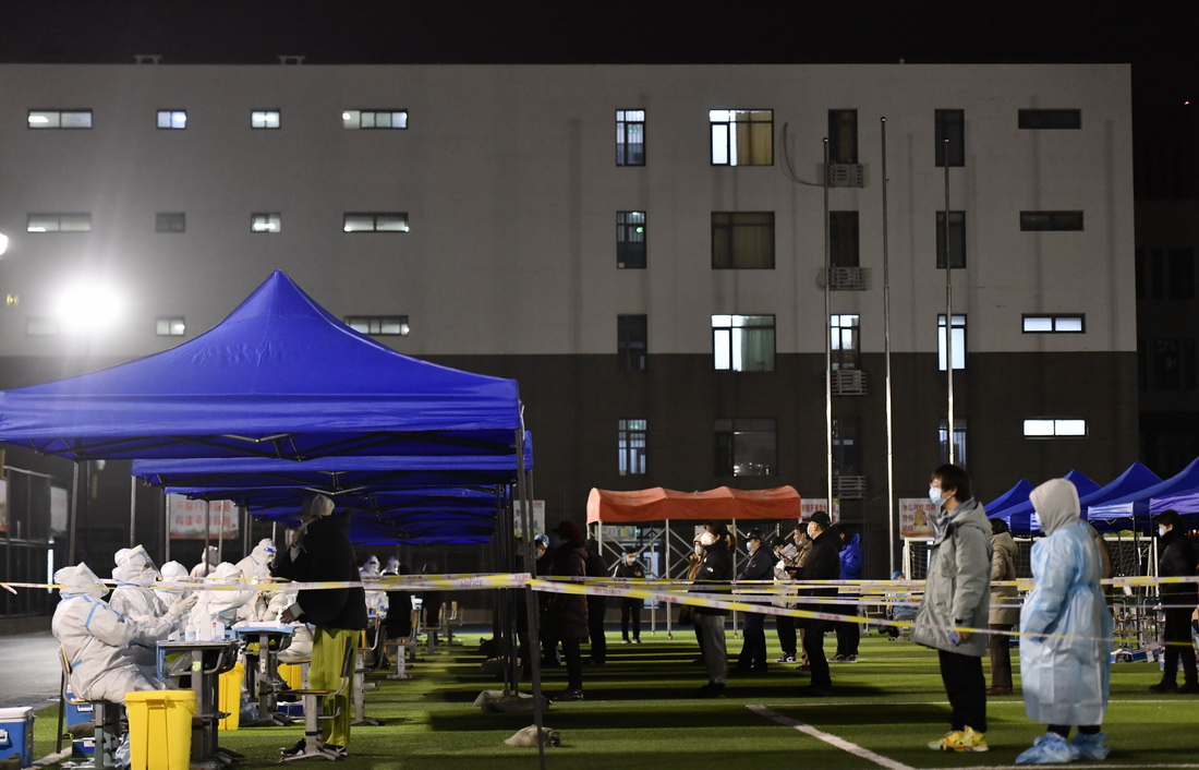 1月9日晚，在天津市南開區鼓樓街道中營小學核酸檢測點，居民排隊准備進行核酸檢測。新華社記者 趙子碩 攝