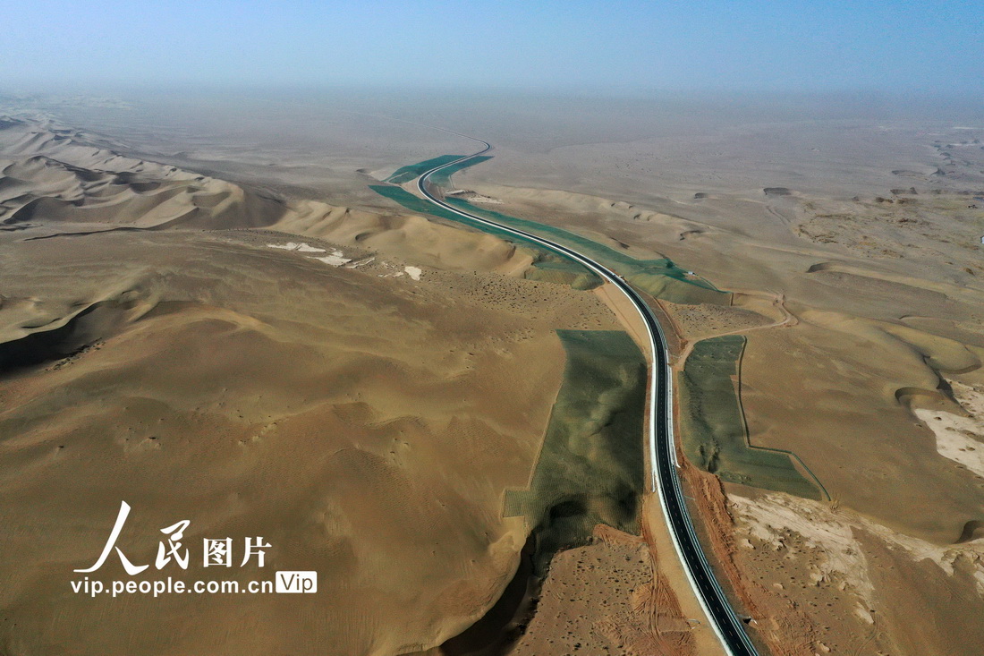 2022年3月4日，在甘肃省酒泉市金塔县的沙漠腹地中，柏油马路从茫茫戈壁沙漠中穿越而过。 