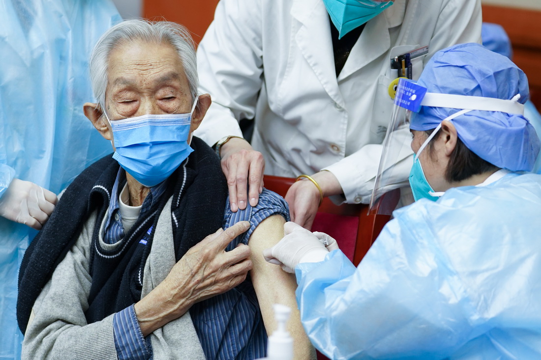 4月18日，医护人员为94岁的老人高�接种新冠疫苗。