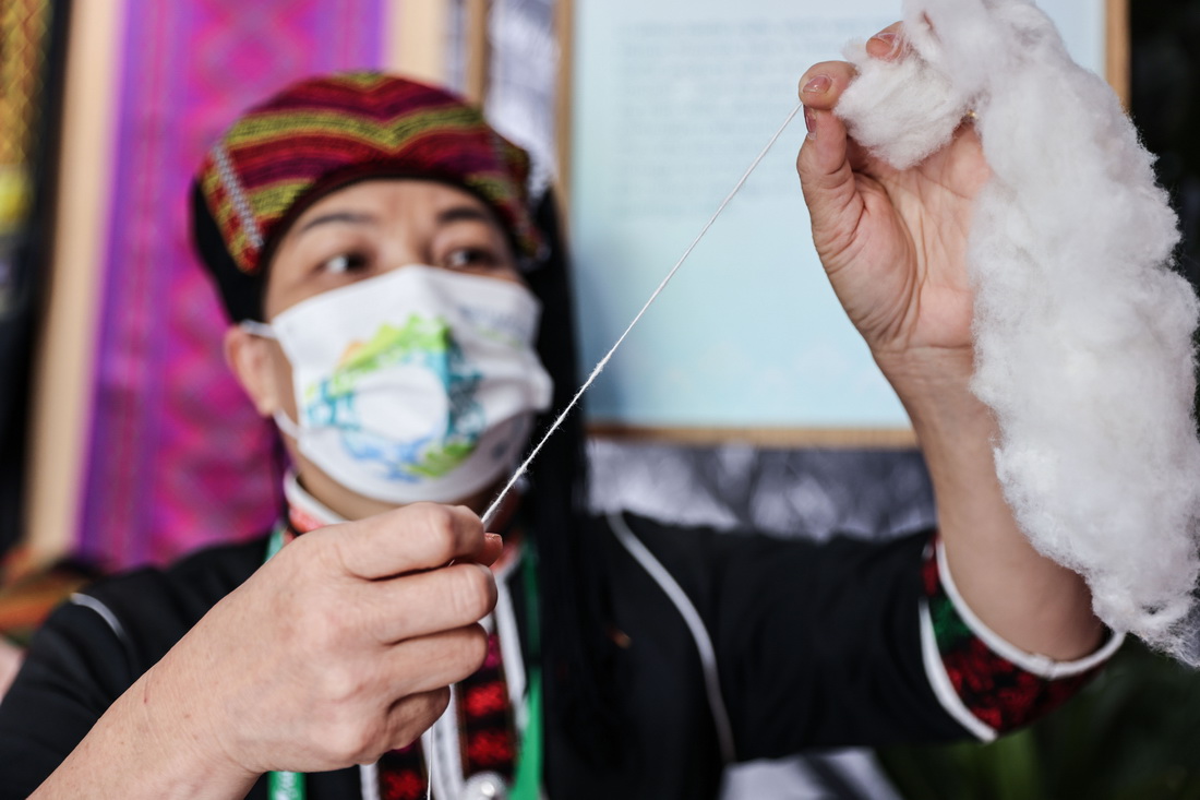 4月20日，黎族妇女在“寻觅雨林・万物共生”热带雨林文化展上展示手工纺线。新华社记者 张丽芸 摄