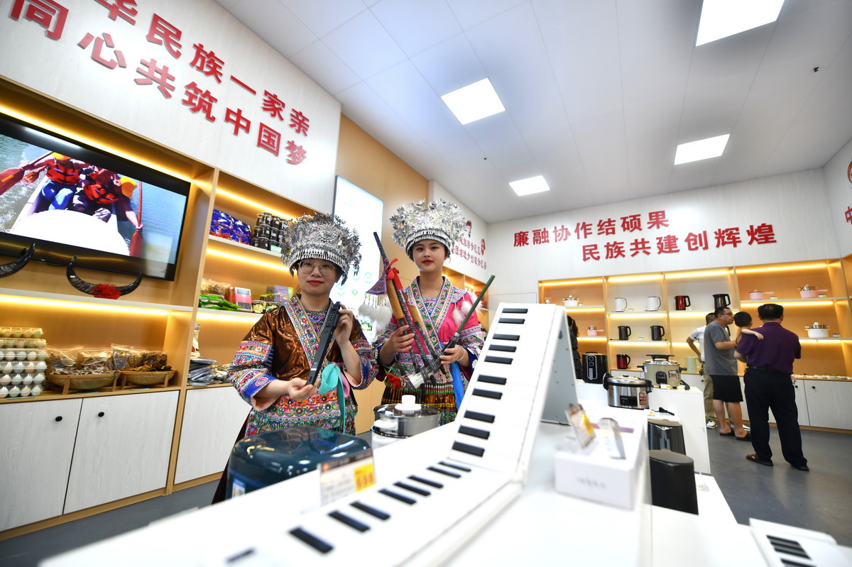 在廉江市·融水苗族自治縣民族團結共建展示中心，工作人員在展示融水苗族樂器和廉江市生產的電子樂器（2022年6月28日攝）。