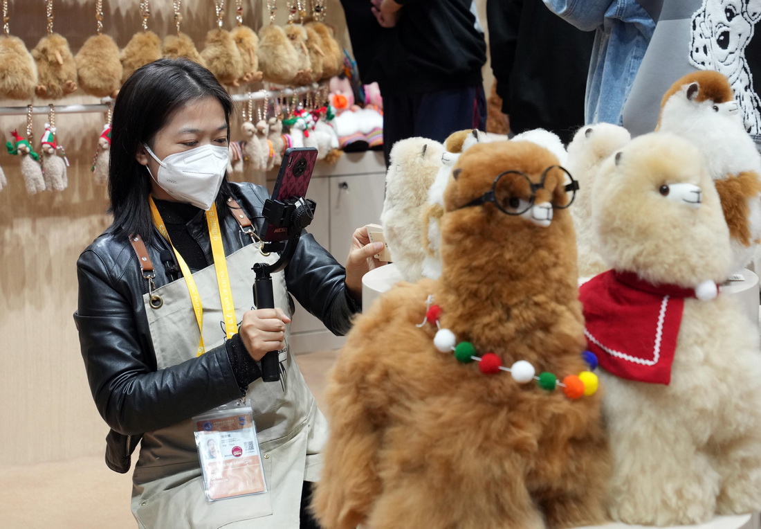 11月8日，“溫暖駝”展台的工作人員在第五屆進博會上直播推介商品。新華社記者 劉穎 攝