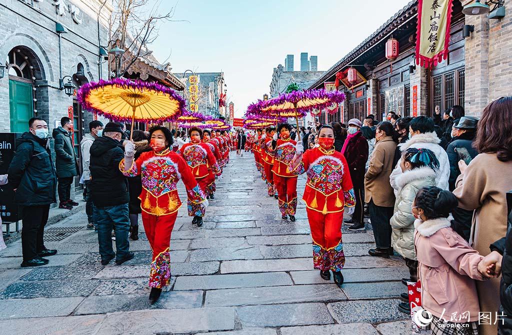 1月25日，山西忻州古城內，花傘秧歌表演穿街而過。人民網記者 王帆攝