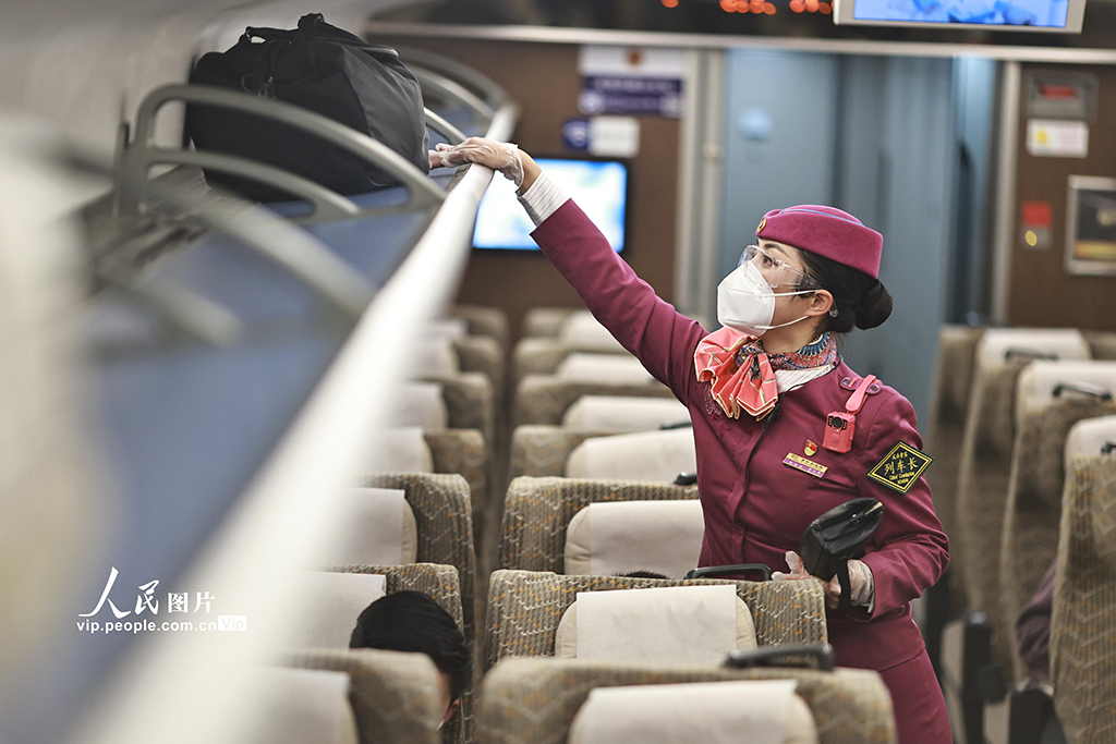 2023年1月26日，重庆，在重庆西站始发的C6035次列车上，列车长戴立静整理行李架。