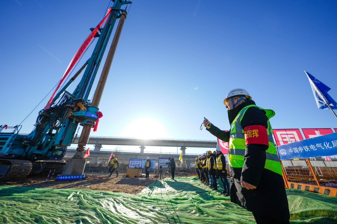 2月25日，中鐵電氣化局的施工人員在雄忻高鐵新蓋房特大橋建設現場指揮鑽孔作業。