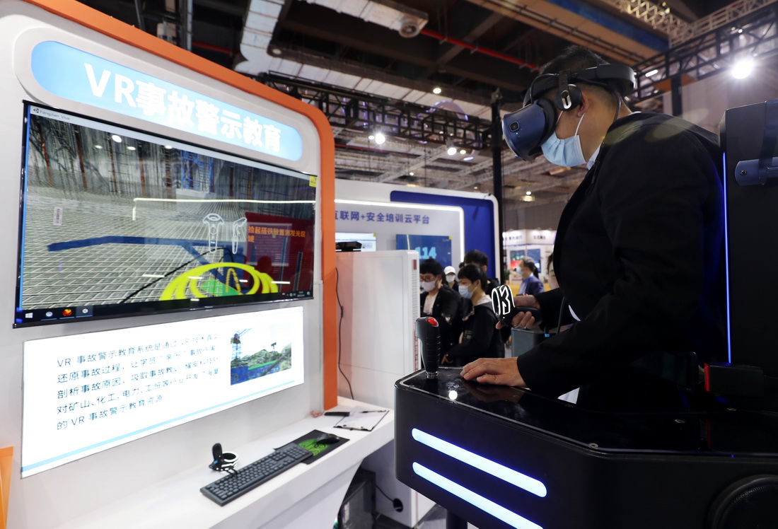 5月8日，参观者在展会上体验一款VR事故警示教育系统。