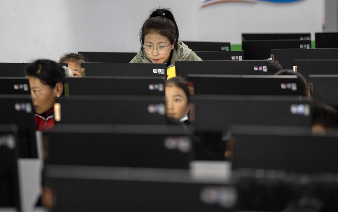 6月5日，拉巴卓玛老师在给扎西宗乡完全小学六年级的学生上计算机课。新华社记者 费茂华 摄