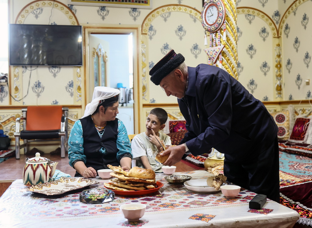 9月5日，巴依卡老人和家人在一起吃晚飯。新華社記者 蘭紅光 攝