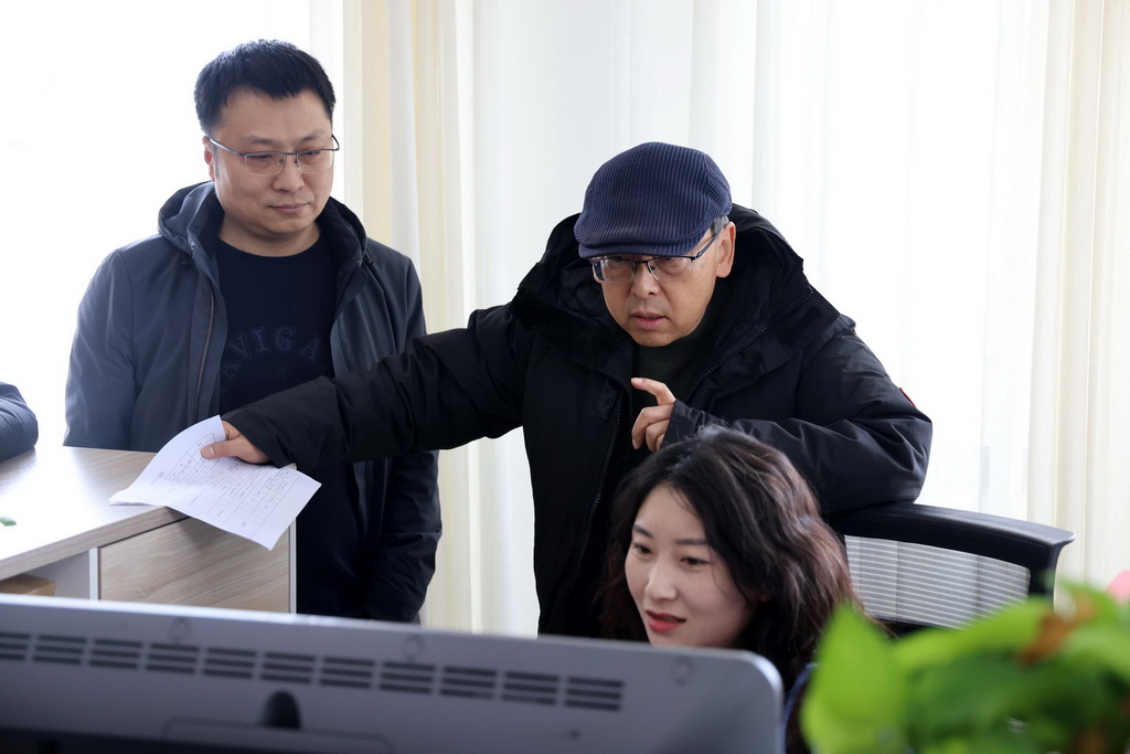 在雲岡研究院數字化保護中心，杭侃（中）和同事交流雲岡石窟數字化技術採集方案（2023年12月29日攝）。新華社發