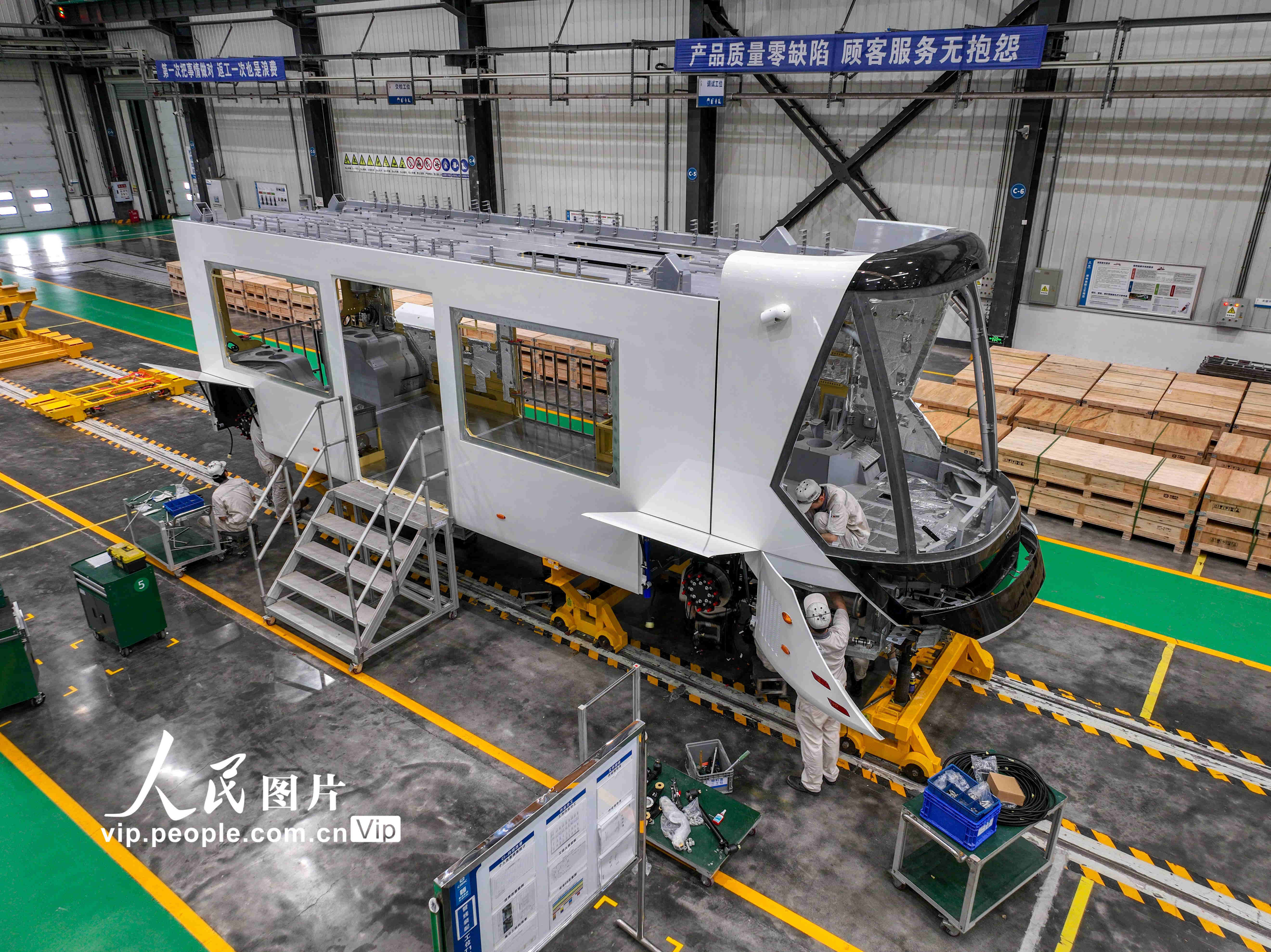 2024年6月4日，在位于四川省宜宾三江新区的中车铁投轨道交通产业基地生产车间，工人们正在各自岗位上为氢能源智轨电车的生产忙碌着。
