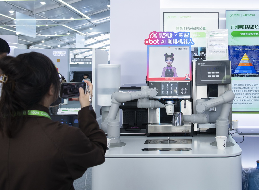 10月24日，观众在第七届世界声博会上参观一款AI咖啡机器人。