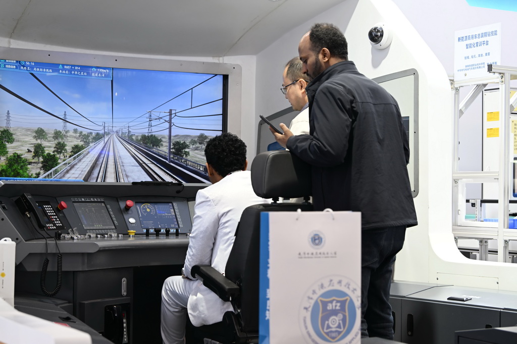 11月21日，参会者在职业教育专题展上体验高铁模拟器。