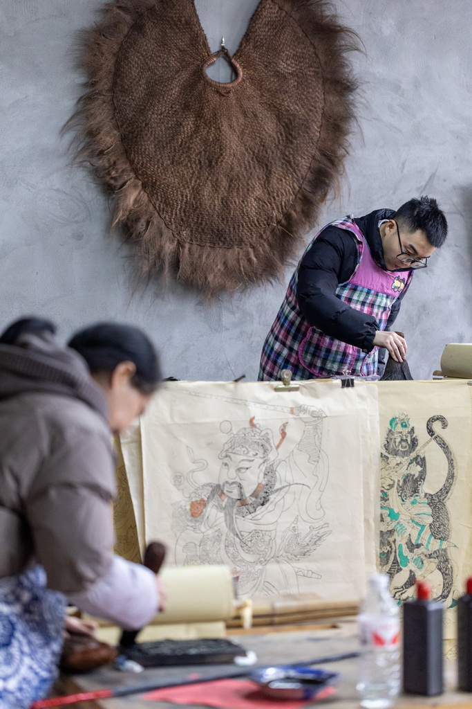 1月14日，在重庆市梁平区屏锦镇，梁平木版年画国家级代表性传承人徐家辉的家人在刷印木版年画。