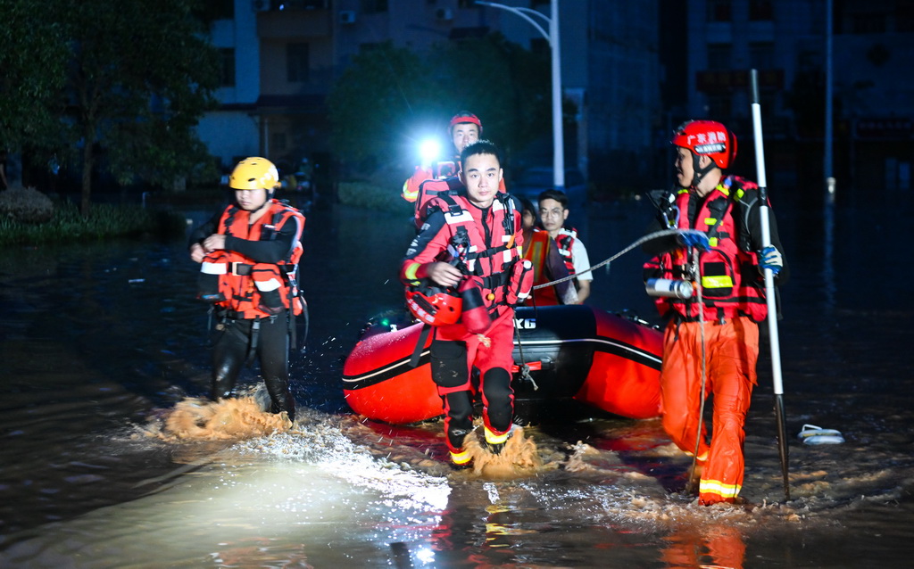6月18日，消防救援人员在广东省肇庆市怀集县城的站前大道转移群众。