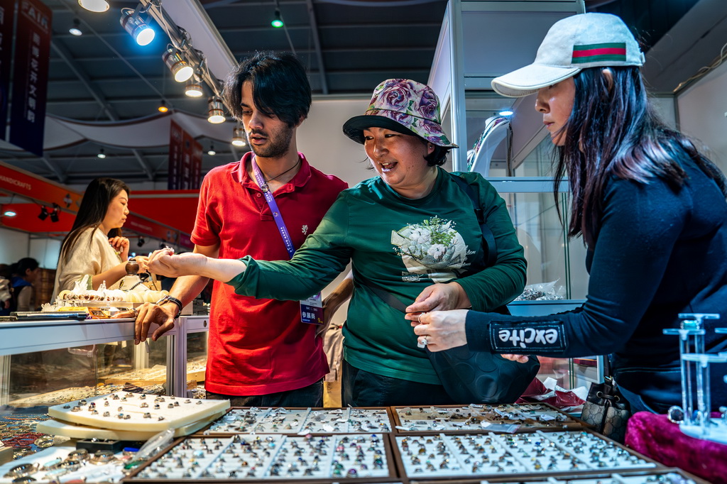 6月24日，游客在第9届中国—南亚博览会印度展区选购特色商品。新华社记者 胡超 摄