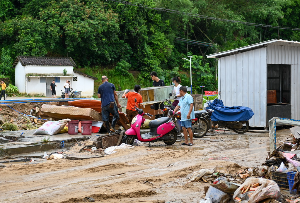 8月6日，村民在广东清远佛冈县石角镇黄花村搬运受损家具。